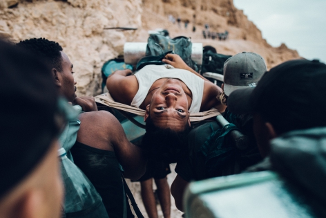  October 25, 2018. Masada. Israel. A group of young people during the ascent of Masada. This fortress is one of the holy places of Judaism. These young Eritreans and Yemenis have just made their Aliyah, they come to live in the Holy Land. Before doing their compulsory military service, they undergo initiations. Some are carried on stretchers, others sing and shout holy words.25 octobre 2018. Masada. Israel. Un groupe de jeunes pendant l'ascension du Masada. Cette forteresse est l'un des lieux saint du Juda?sme. Ces jeunes ?rythr?ens et y?m?nites viennent de faire leur Aliyah, ils viennent vivre en Terre Sainte. Avant de faire leur service militaire obligatoire, ils passent des initiations. Certains sont port?s sur des brancards, d'autres chantent et crient des paroles saintes.